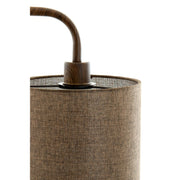 Detailopname van een bruine cilindrische lampenkap met een donkere, houten gebogen arm.